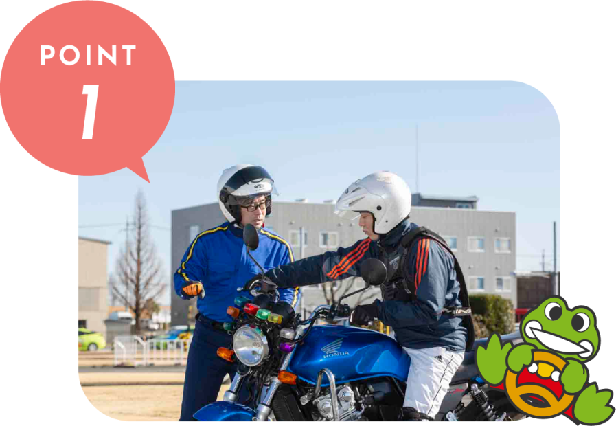two people wearing helmets on a motorcycle