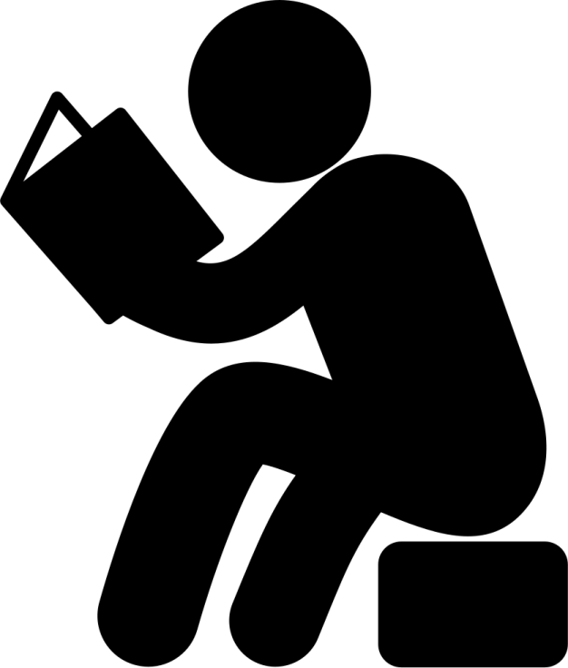 a person sitting on the ground reading a book