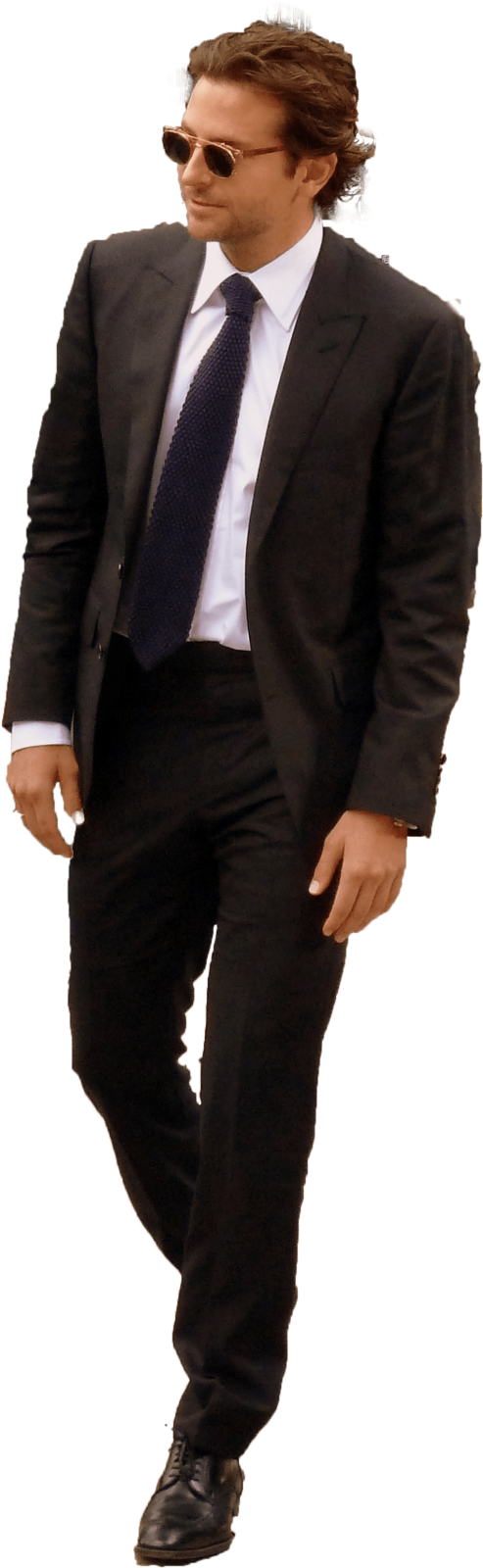 a man in a suit and tie is walking