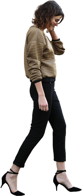 a woman in black pants and a brown sweater