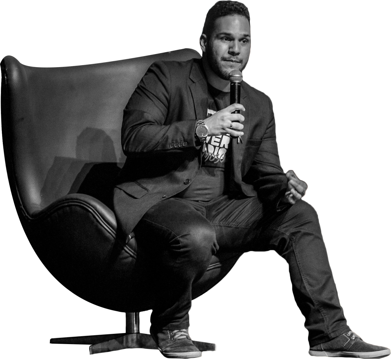 a black and white photo of a man sitting in a chair