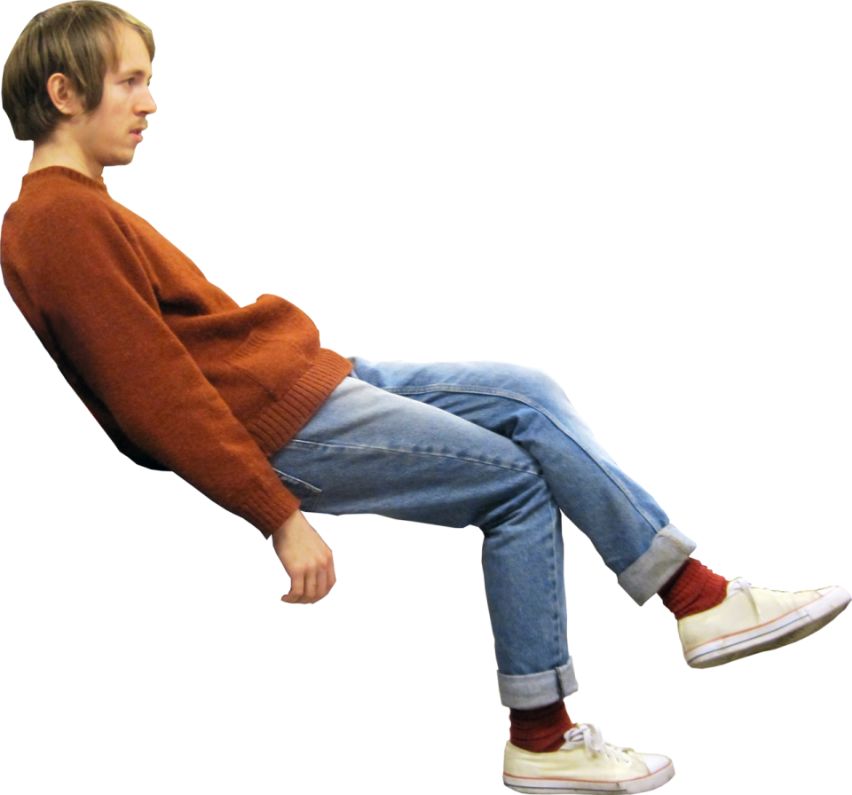a young boy sitting on a white background