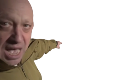 a man in a green jacket is pointing at the camera