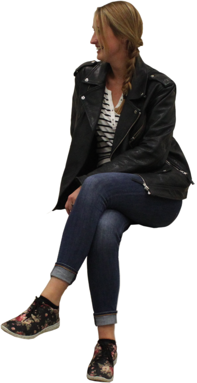 a woman sitting on the ground wearing a black leather jacket