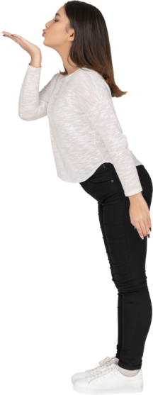 a woman in black pants and a white sweater