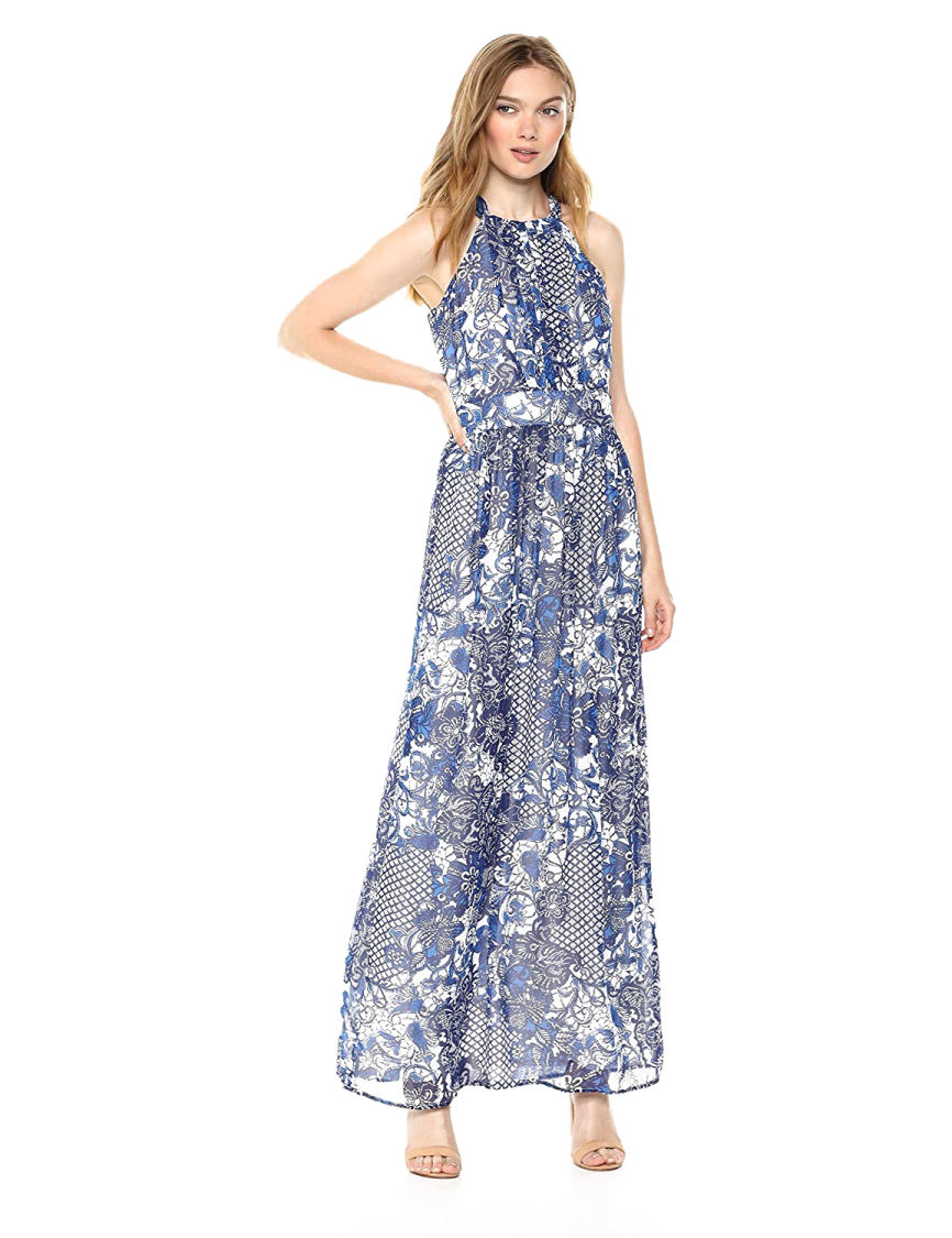 a woman wearing a blue and white floral print maxi dress