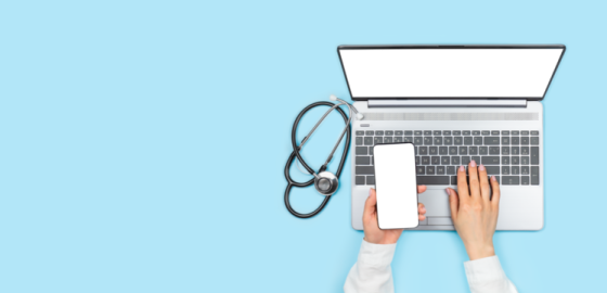 a person typing on a laptop with a stel