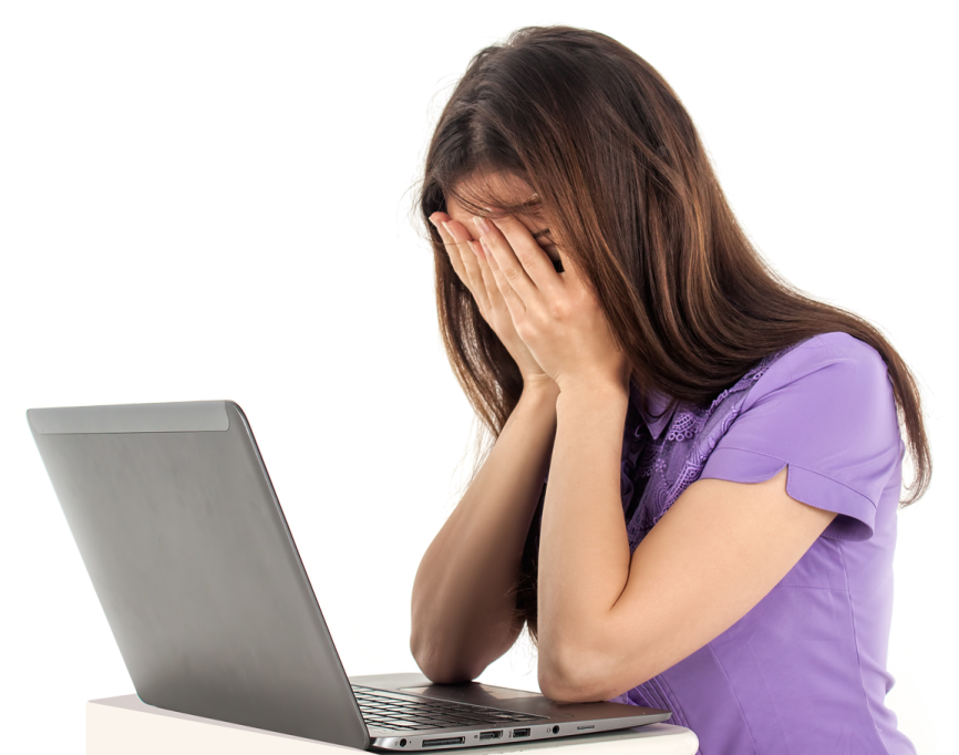 a woman with her head in her hands while looking at her laptop