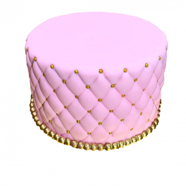 a pink cake with gold decorations on top