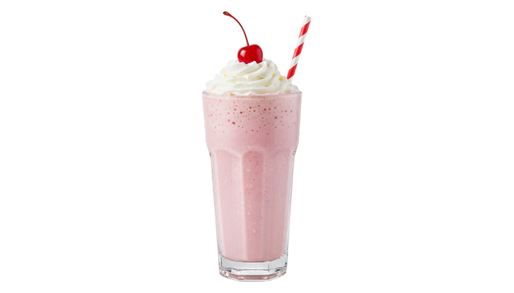 a glass filled with milk and topped with whipped