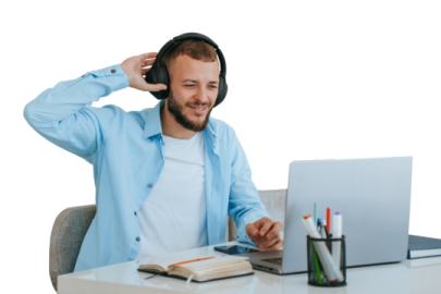 a man sitting at a desk with headphones on