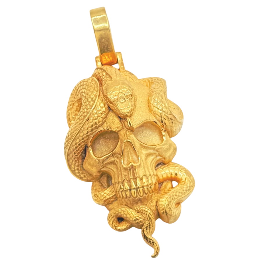 a gold skull pendant on a white background