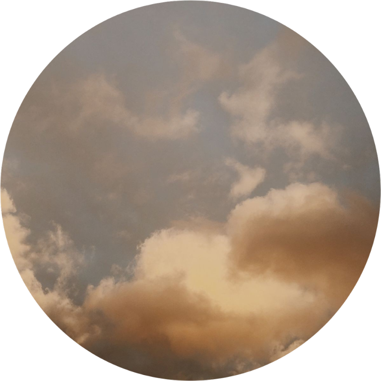 a circle with clouds in the sky
