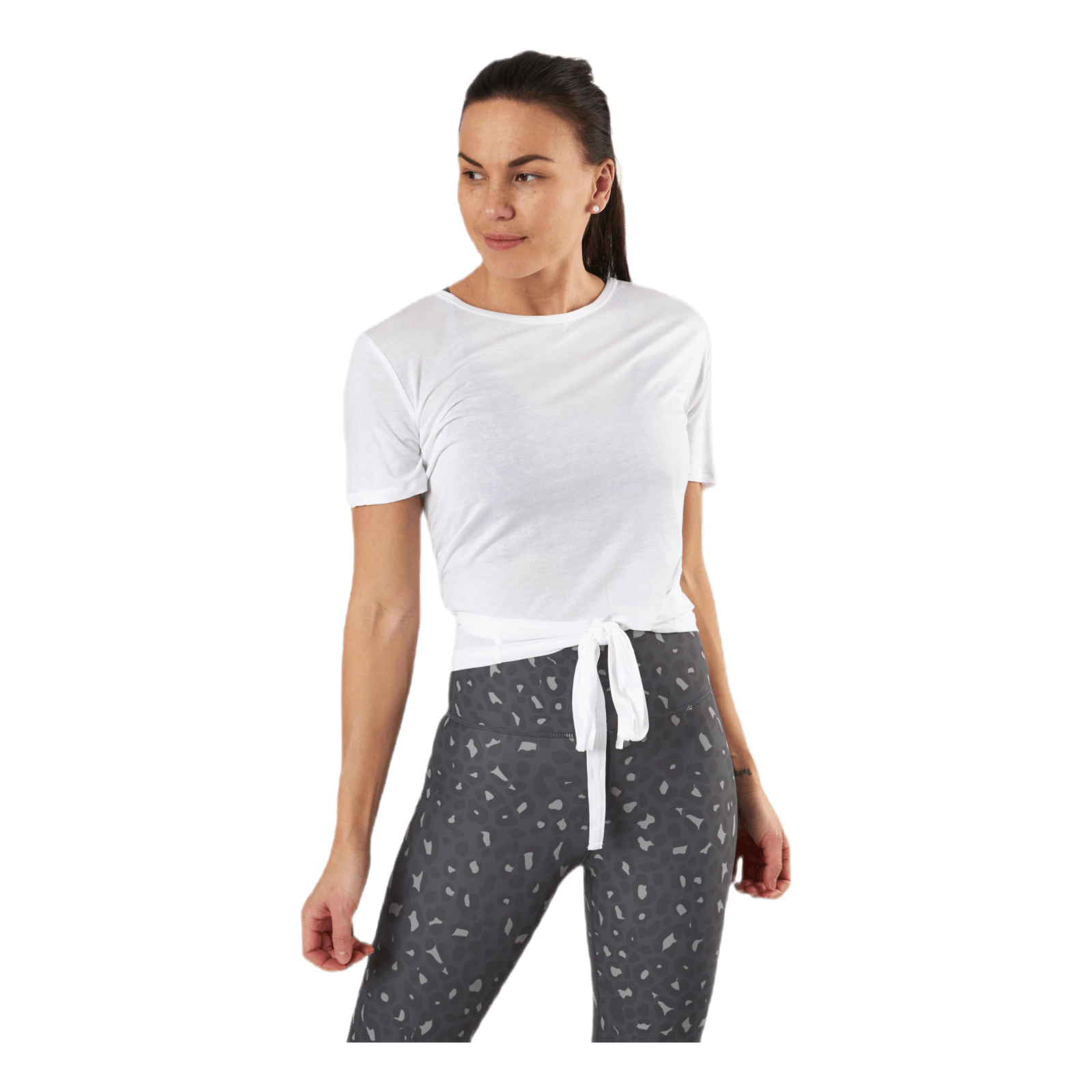 a woman wearing a white t - shirt and black pants