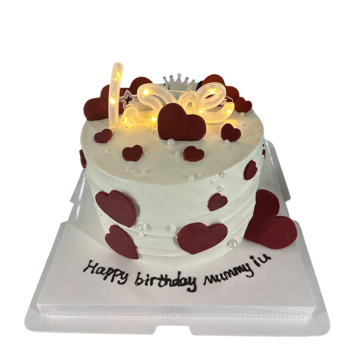 a white cake with red hearts on top