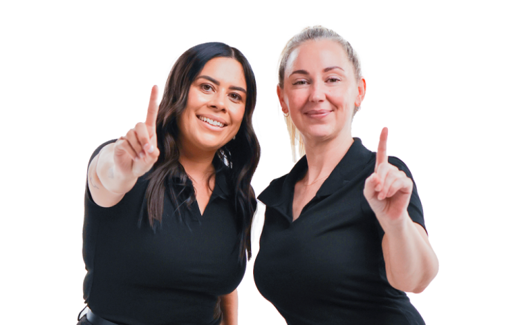 two women giving a thumbs up sign