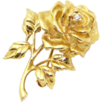 a gold rose with leaves on it
