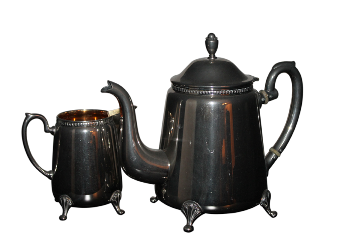 a black coffee pot and a silver teapot
