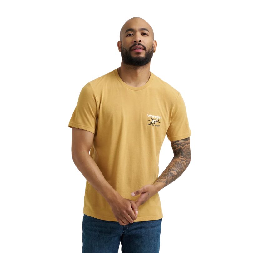 a man wearing a yellow t - shirt and blue jeans