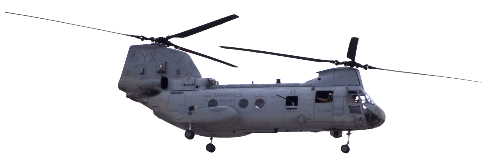 a military helicopter flying in the sky