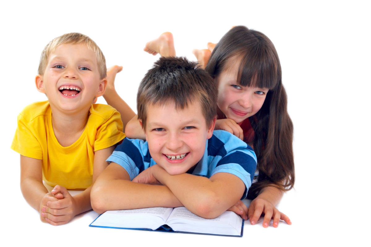 three children laying on the floor and smiling