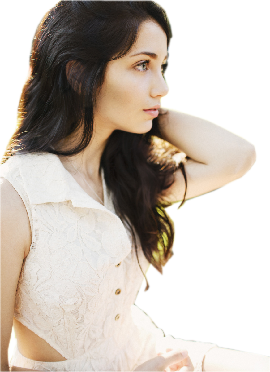a woman in a white dress posing for the camera