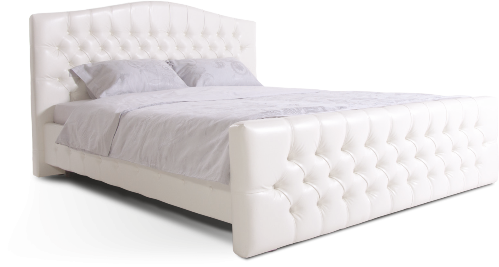 a white bed with an upholing headboard