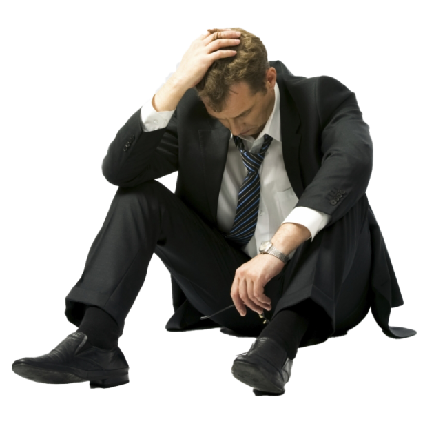 a man in a suit and tie sitting on the ground
