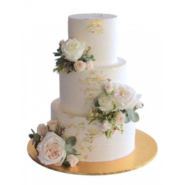 a white and gold wedding cake with flowers