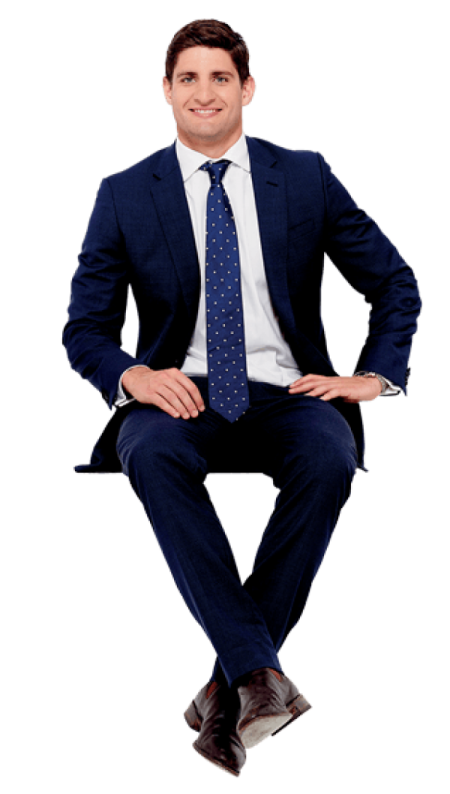 a man in a suit and tie sitting on a chair