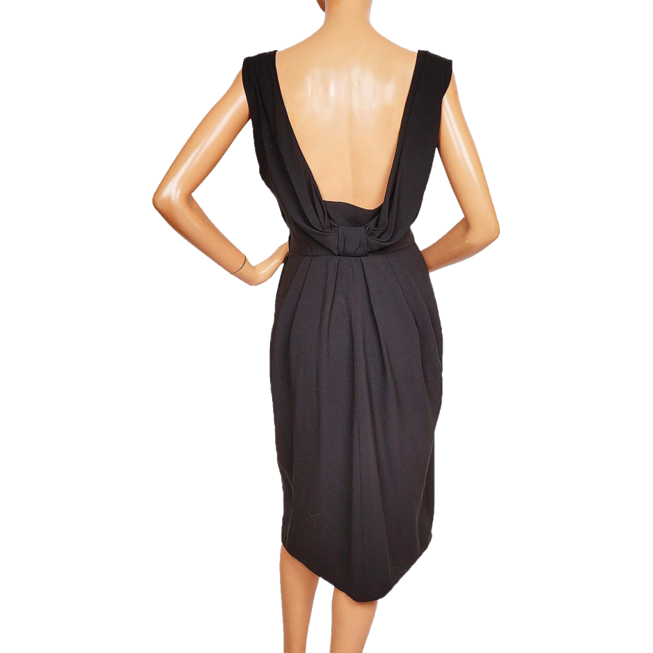 a woman wearing a black dress with an open back