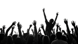 a crowd of people raising their hands in the air