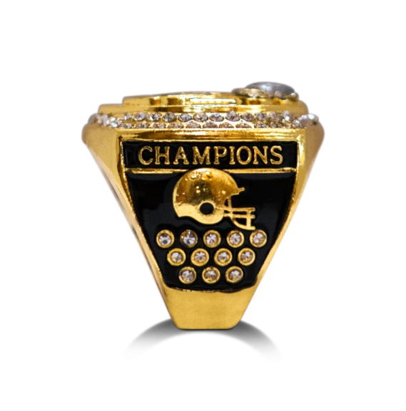 a gold and black ring with diamonds on it