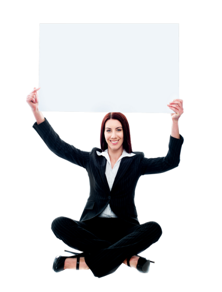 a woman sitting on the floor holding up a sign