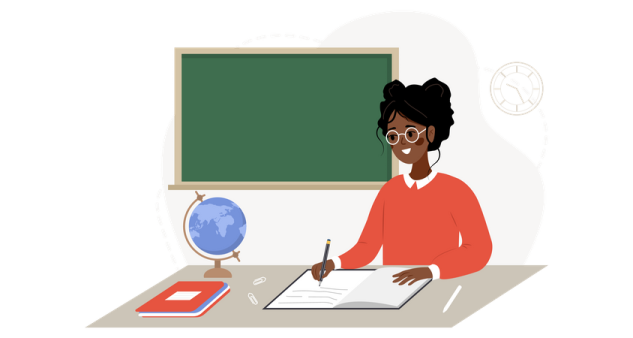 a woman sitting at a desk in front of a blackboard