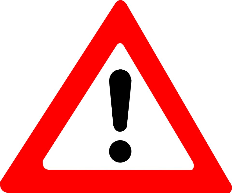 a red triangle with a black and white sign on it