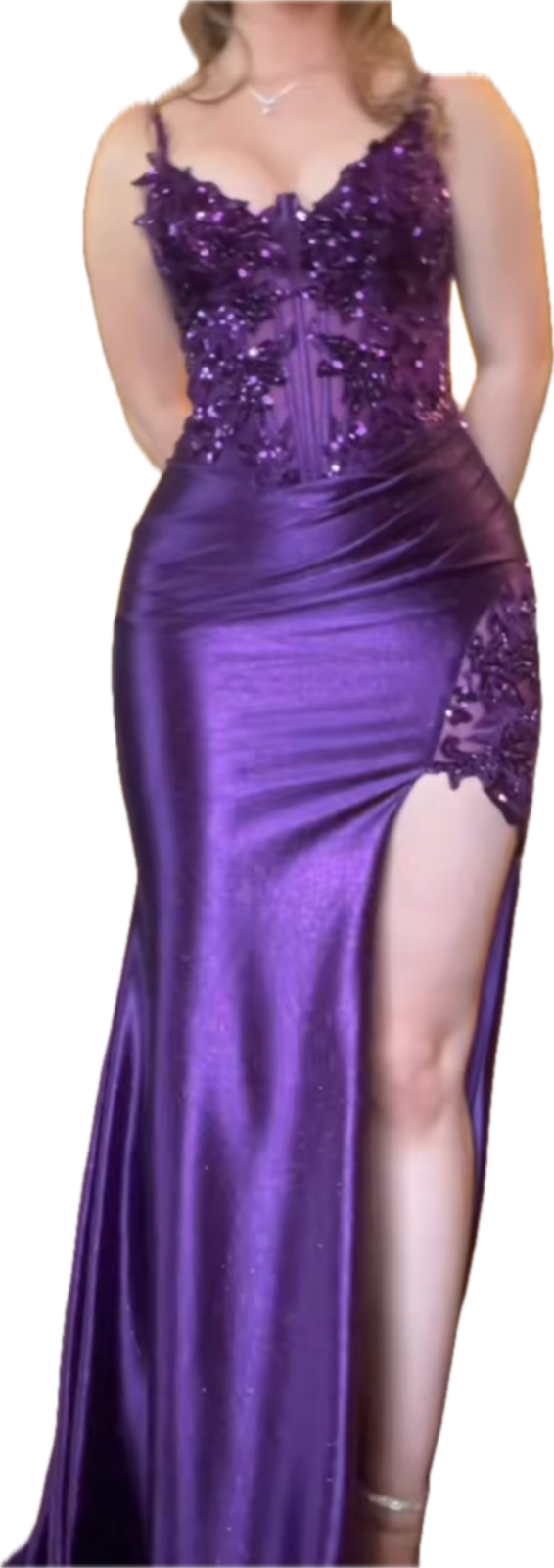 a woman in a purple dress posing for the camera