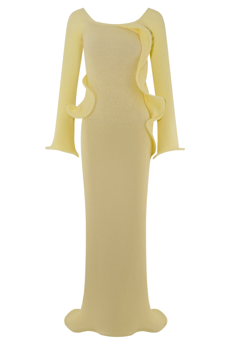 a woman wearing a yellow dress with long sleeves