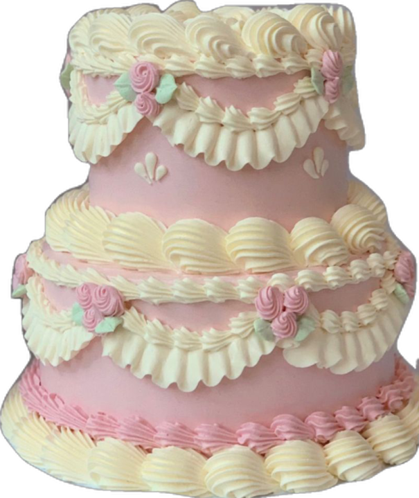 a three tier cake with pink and white frosting
