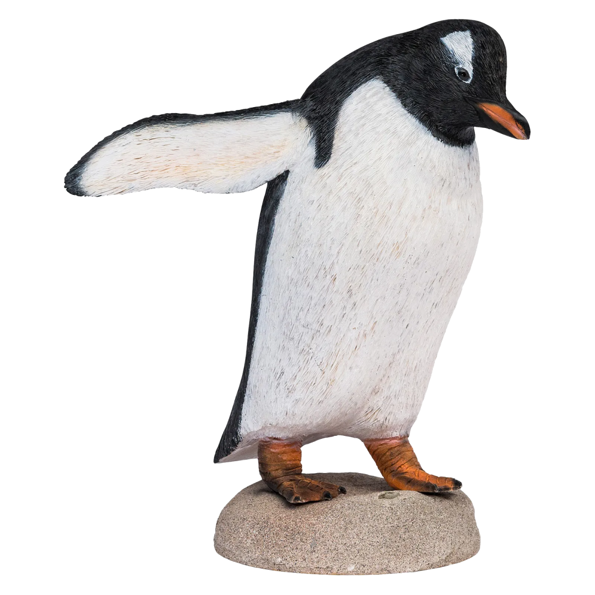 a black and white penguin standing on a rock