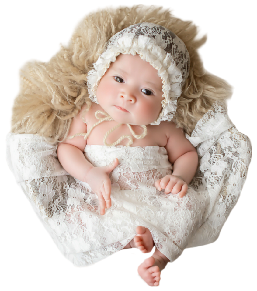 a baby doll in a white dress and bonnet