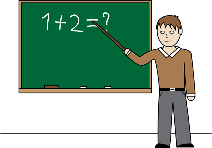 a man standing in front of a blackboard