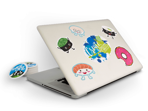 a laptop computer with stickers on it