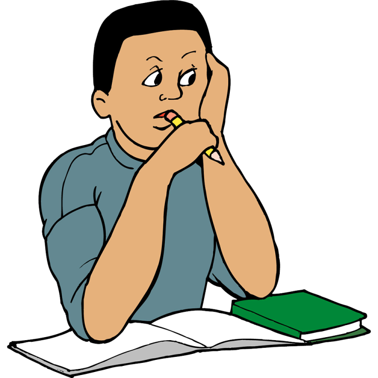 a boy sitting at his desk reading a book