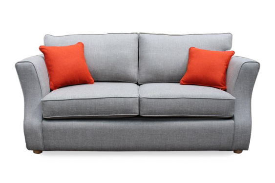 a grey sofa with orange pillows