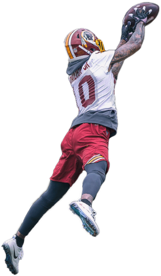 a man in the air catching a football ball
