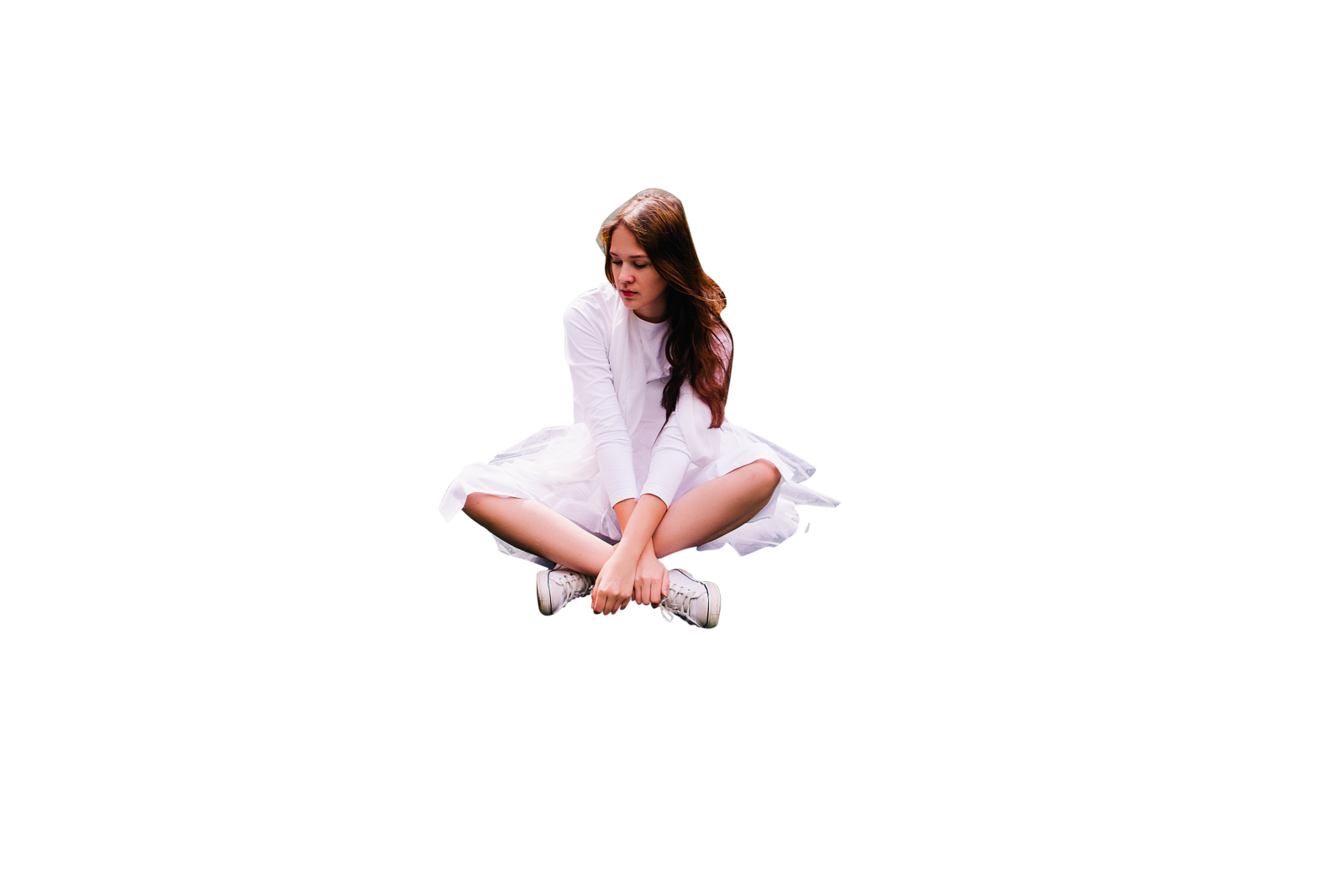 a woman sitting on the floor with her legs crossed