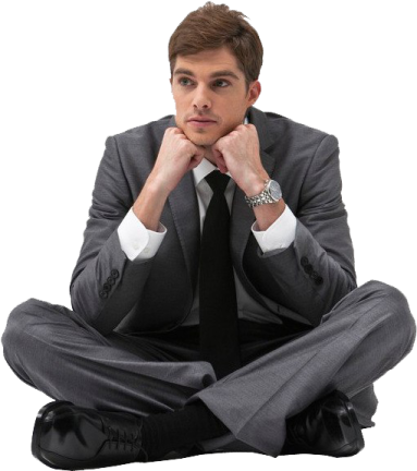 a man in a suit and tie sitting on the floor