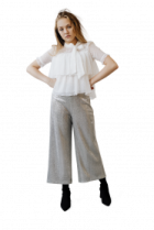 a woman in a white shirt and grey pants