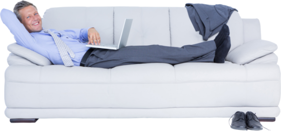 a man laying on a couch with his laptop